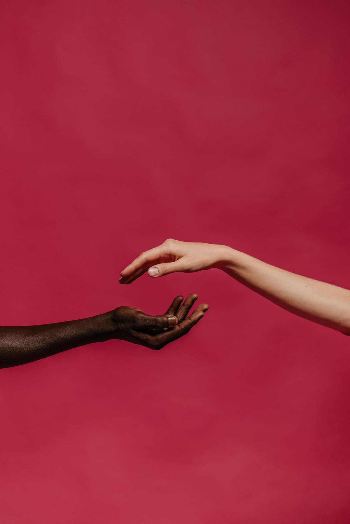Two hands reaching toward each other
